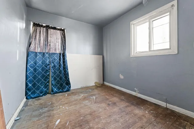 an empty room with windows and closet