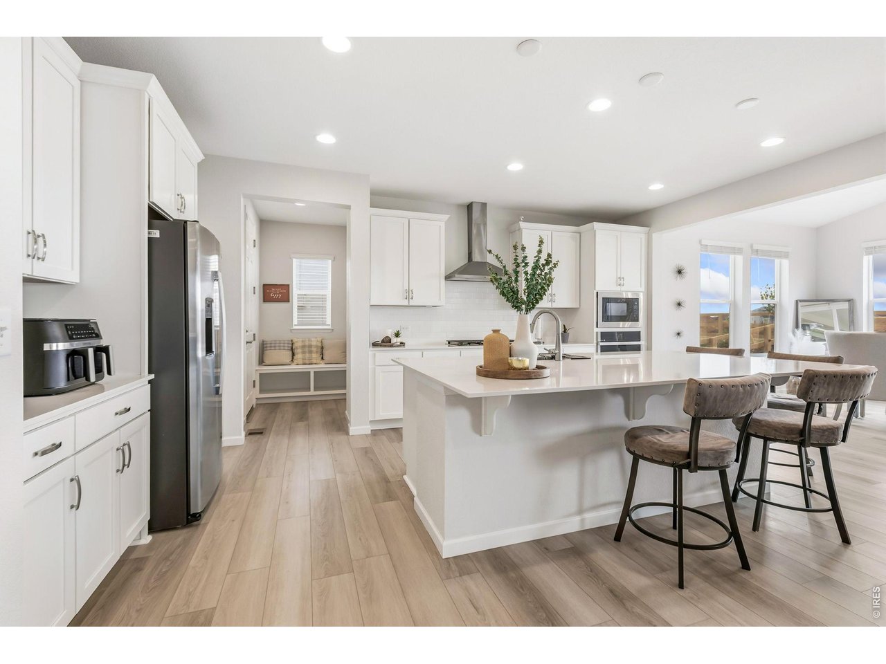 955 Rustling Street Windsor, CO 80550 - Photo 6 of 34 a open kitchen with white cabinets and stainless steel appliances