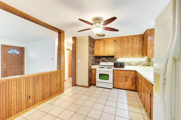 a kitchen with a stove a sink and a refrigerator