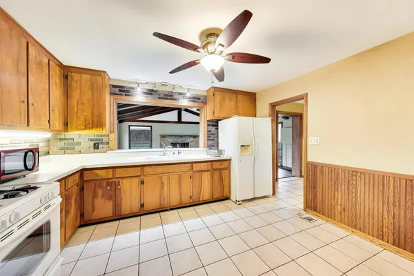 a kitchen with stainless steel appliances granite countertop a sink and cabinets