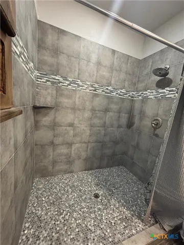 a backyard of a house with plants and wooden fence