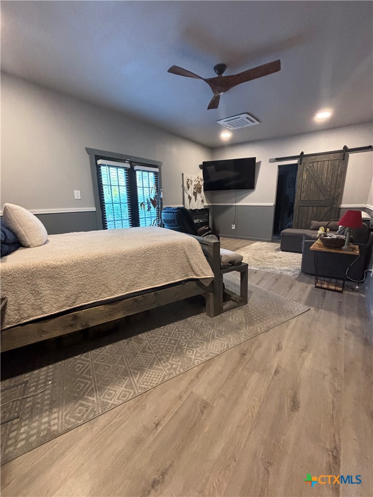 1754 West Big Elm Road Troy, TX 76579 - Photo 19 of 31 a spacious bedroom with a bed window and a couch