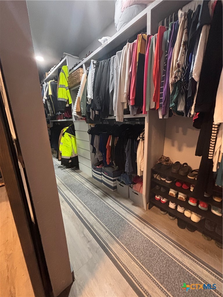 1754 West Big Elm Road Troy, TX 76579 - Photo 23 of 31 a view of walk in closet with clothes and shoes