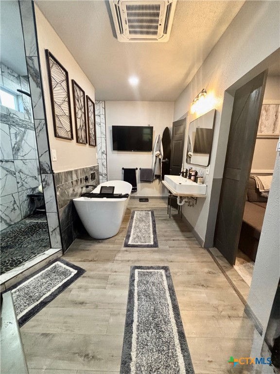 1754 West Big Elm Road Troy, TX 76579 - Photo 26 of 31 a living room with furniture a flat screen tv and a floor to ceiling window