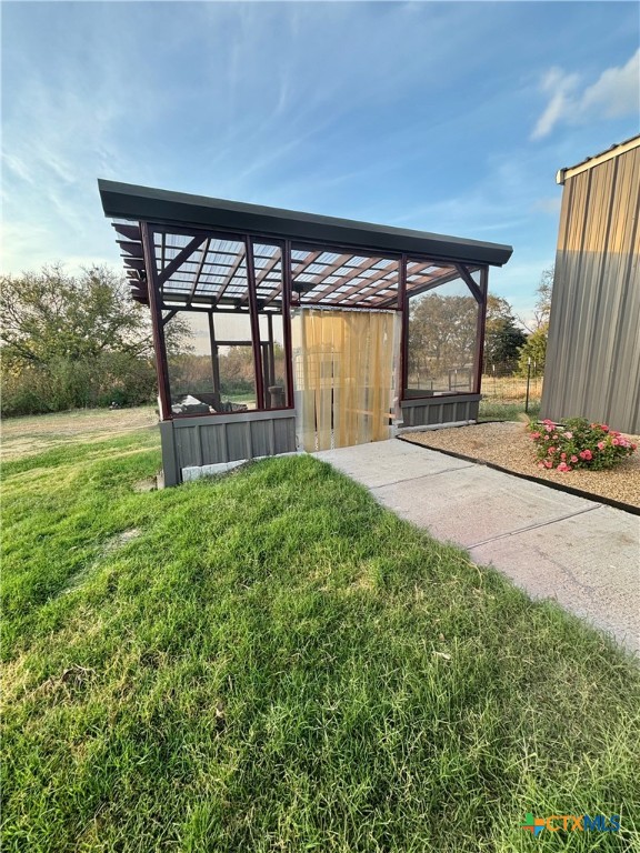 1754 West Big Elm Road Troy, TX 76579 - Photo 3 of 31 a view of a backyard with table and chairs and wooden fence