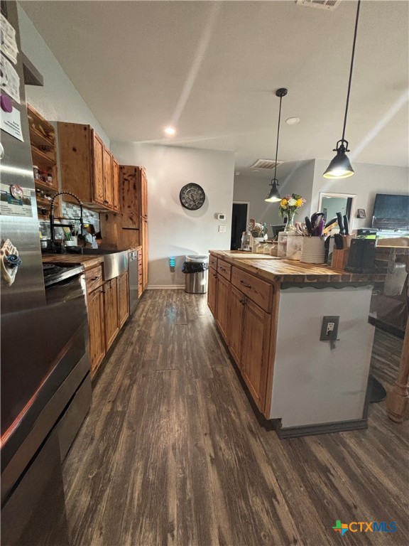 1754 West Big Elm Road Troy, TX 76579 - Photo 9 of 31 a kitchen with stainless steel appliances granite countertop a sink a stove and a wooden floors