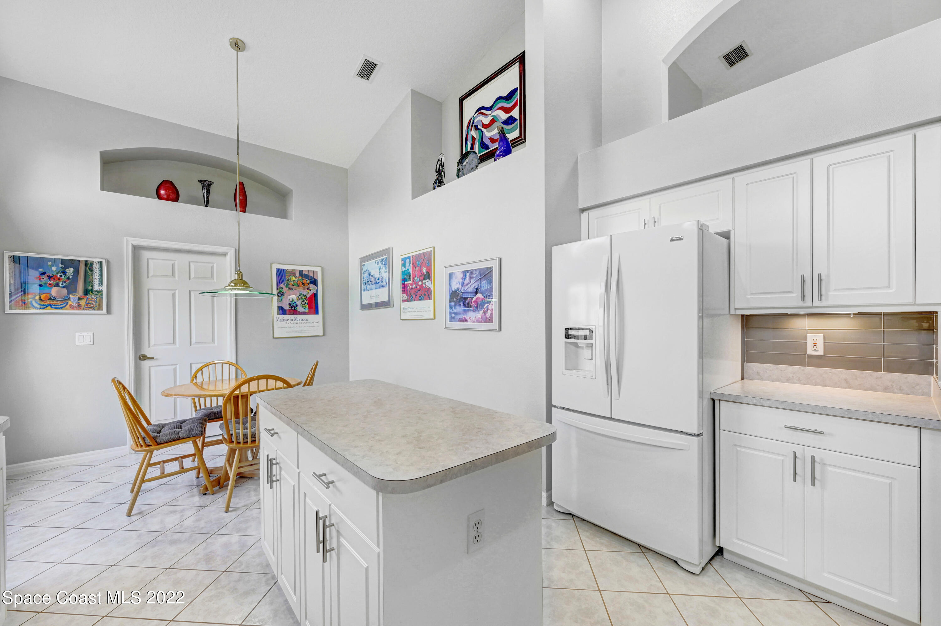 348 Renaissance Avenue Melbourne, FL 32940 - Photo 12 of 31 a white kitchen with cabinets and stainless steel appliances