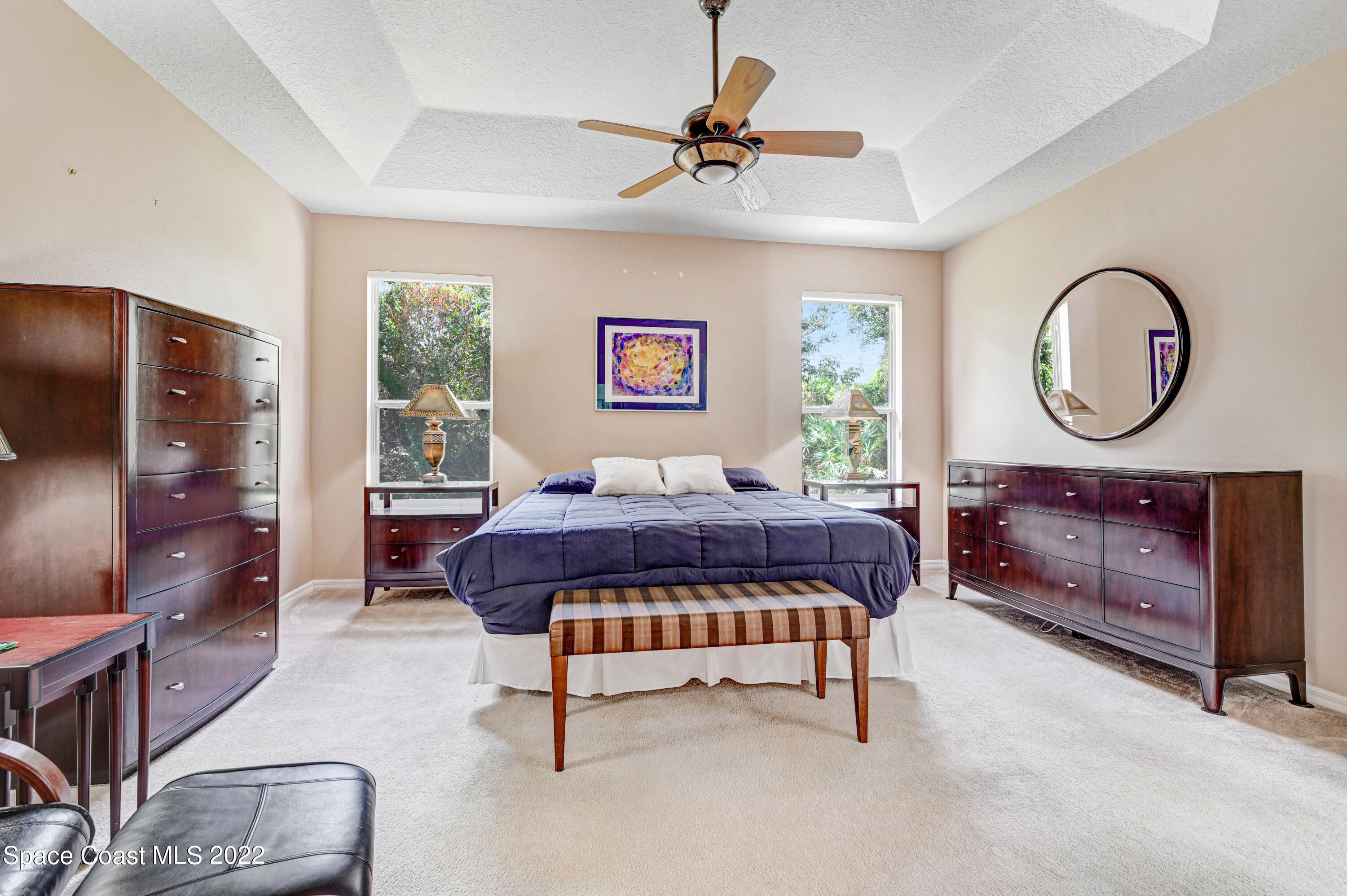 348 Renaissance Avenue Melbourne, FL 32940 - Photo 16 of 31 a bedroom with a bed closet and flat tv screen