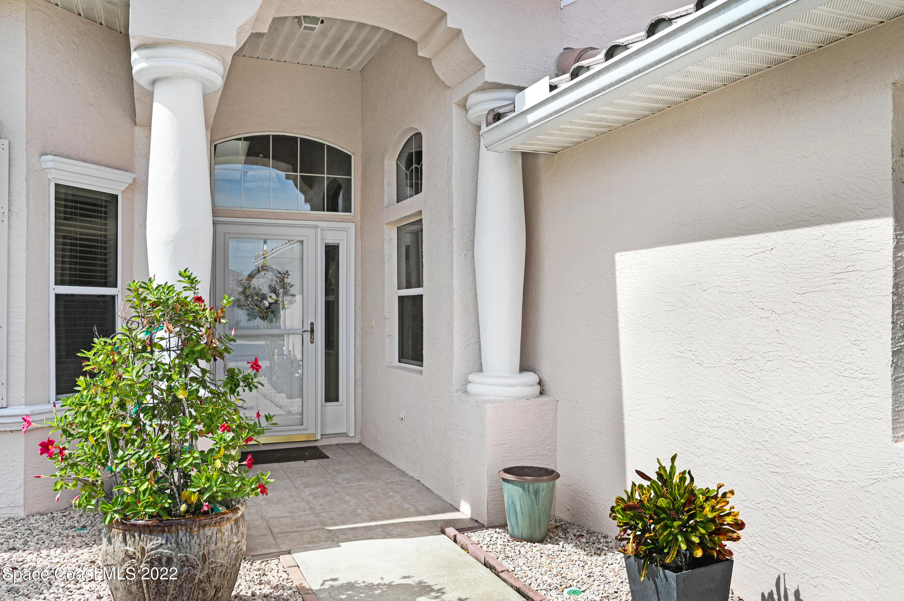 348 Renaissance Avenue Melbourne, FL 32940 - Photo 3 of 31 a front view of a house with plants