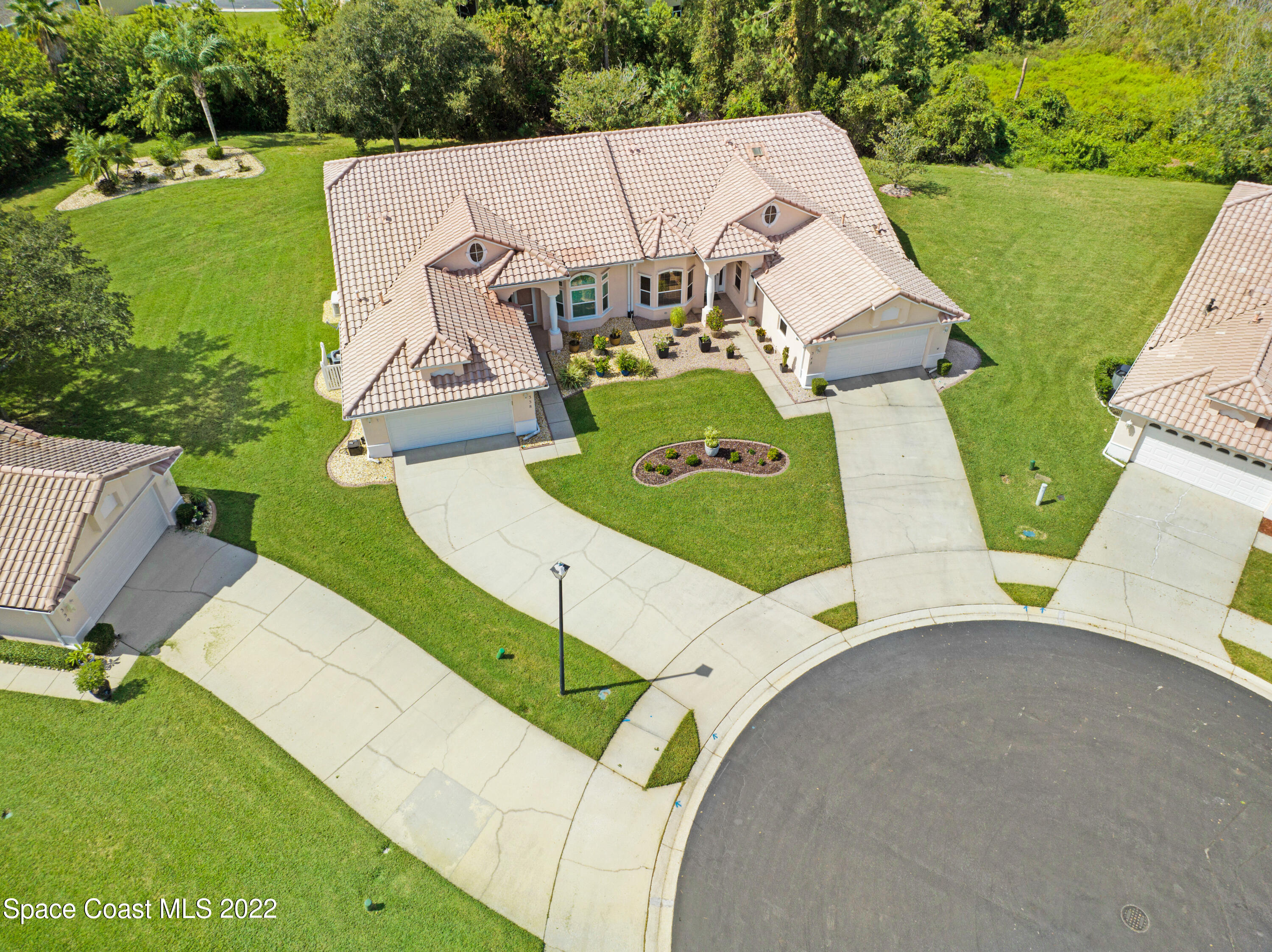 348 Renaissance Avenue Melbourne, FL 32940 - Photo 4 of 31 an aerial view of a house with a garden and trees
