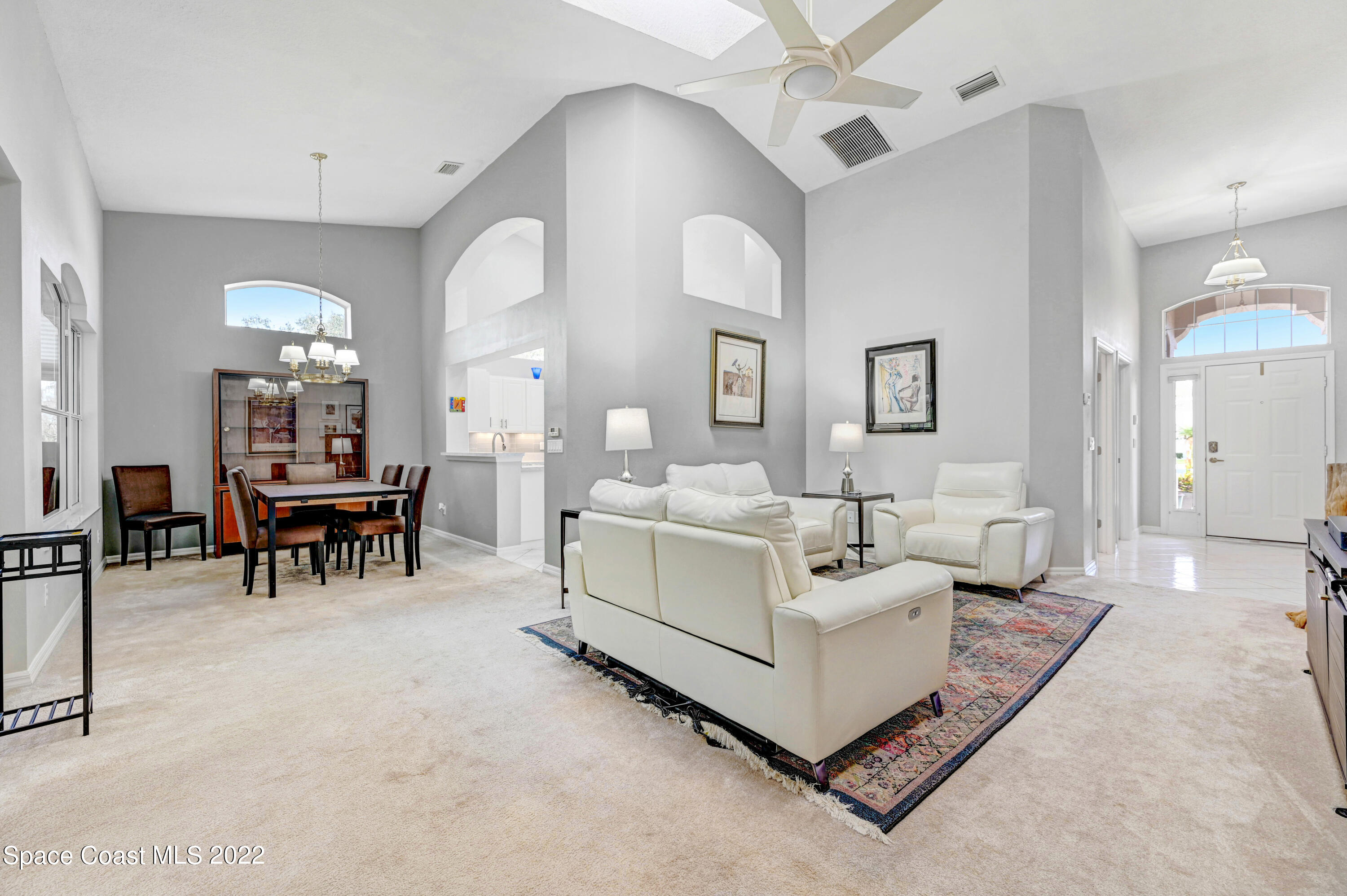 348 Renaissance Avenue Melbourne, FL 32940 - Photo 8 of 31 a living room with furniture and a chandelier