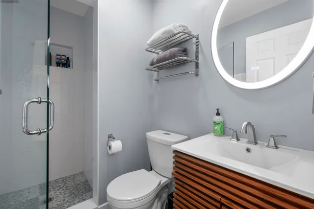 a bathroom with a sink a toilet and a mirror