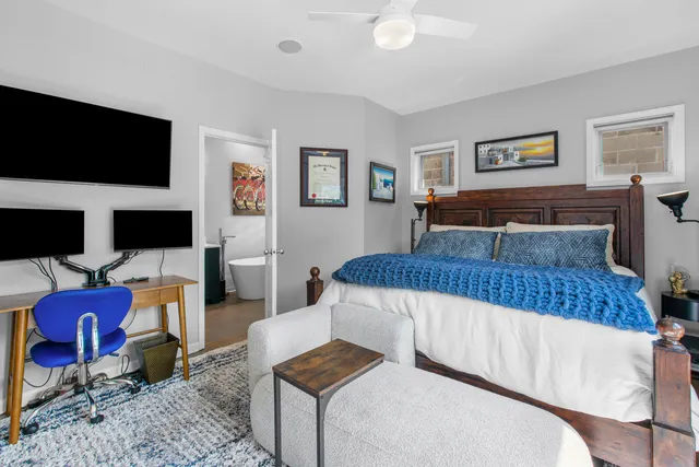 a bedroom with furniture and a flat screen tv