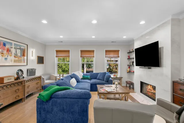 a living room with fireplace furniture and a flat screen tv