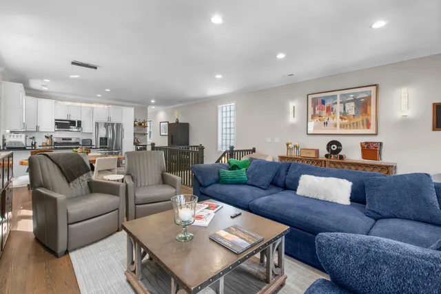 a living room with furniture kitchen view and a table