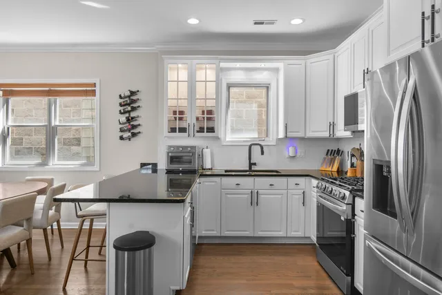 a kitchen with appliances a sink and cabinets