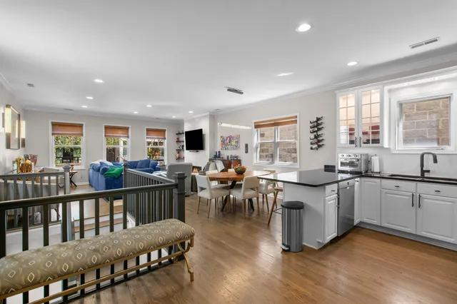 a very nice looking living room with kitchen island furniture and a wooden floor