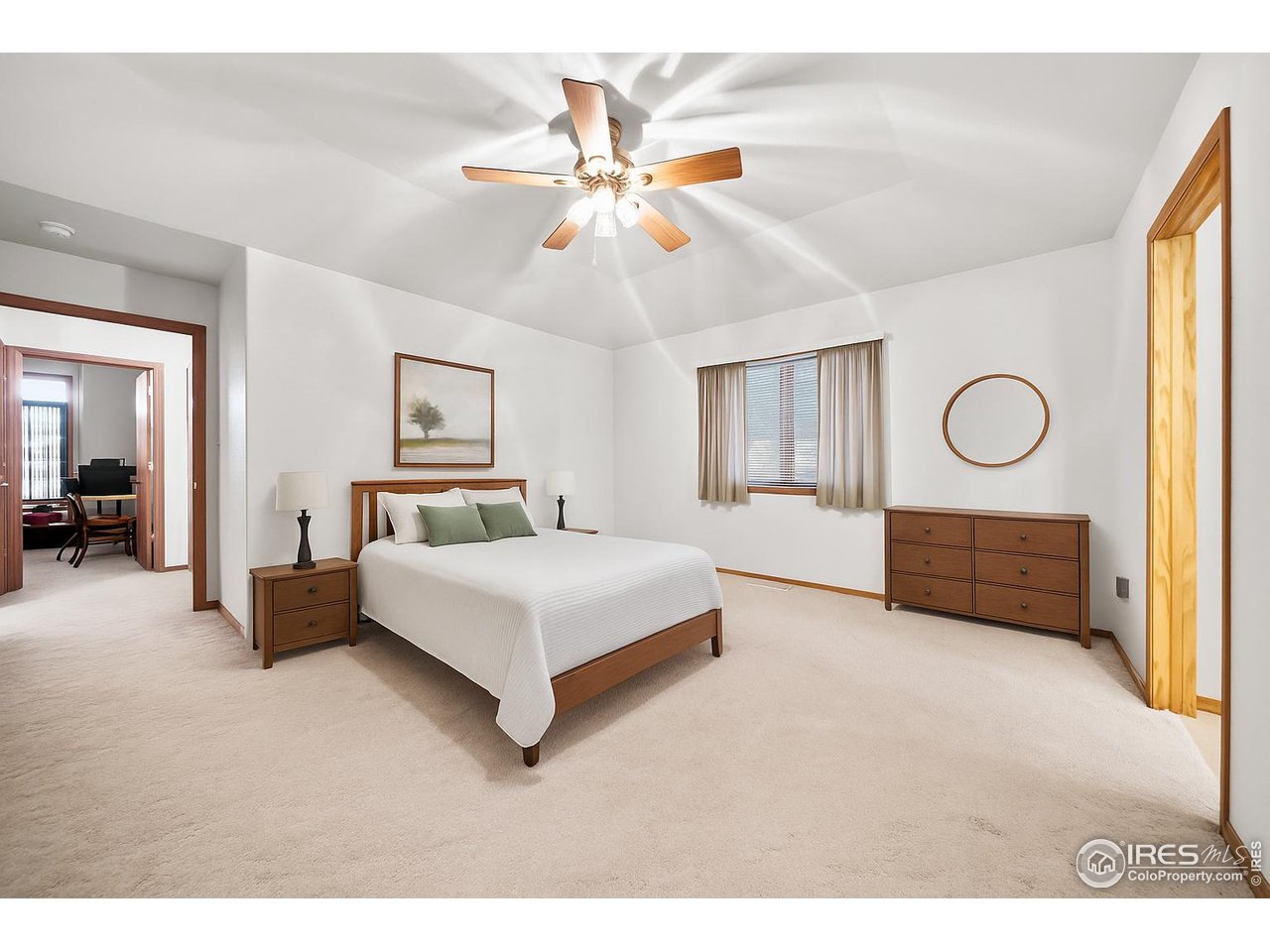 17680 County Rd Q.8 Fort Morgan, CO 80701 - Photo 11 of 40 a bedroom with a bed and a chandelier