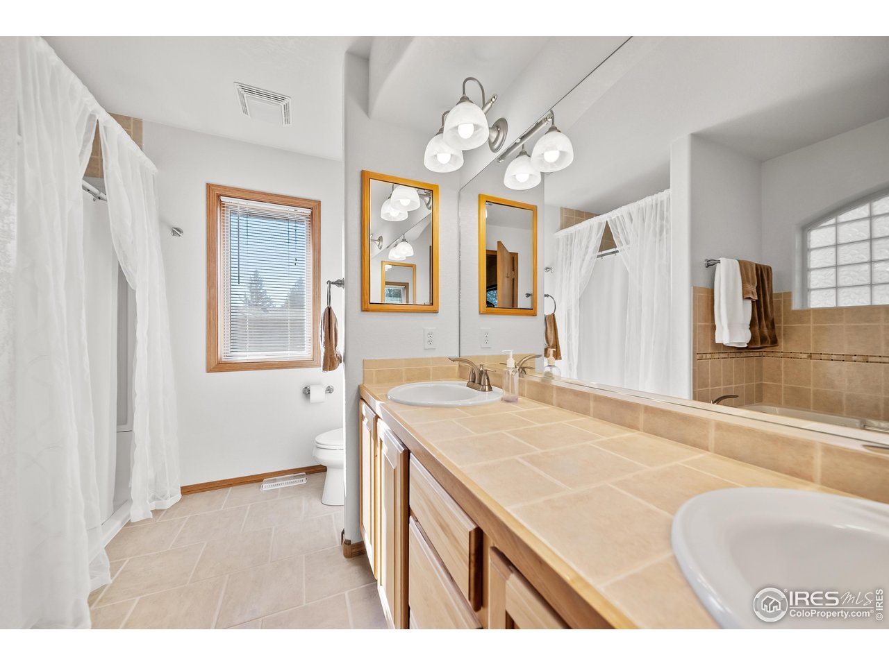 17680 County Rd Q.8 Fort Morgan, CO 80701 - Photo 12 of 40 a bathroom with a sink a vanity and a mirror