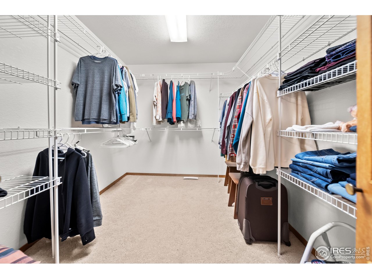 17680 County Rd Q.8 Fort Morgan, CO 80701 - Photo 14 of 40 a view of walk in closet with clothes and shoes