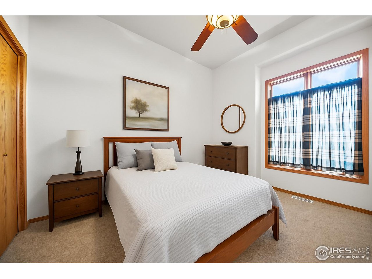 17680 County Rd Q.8 Fort Morgan, CO 80701 - Photo 15 of 40 a bedroom with a bed a painting on the wall and a large window