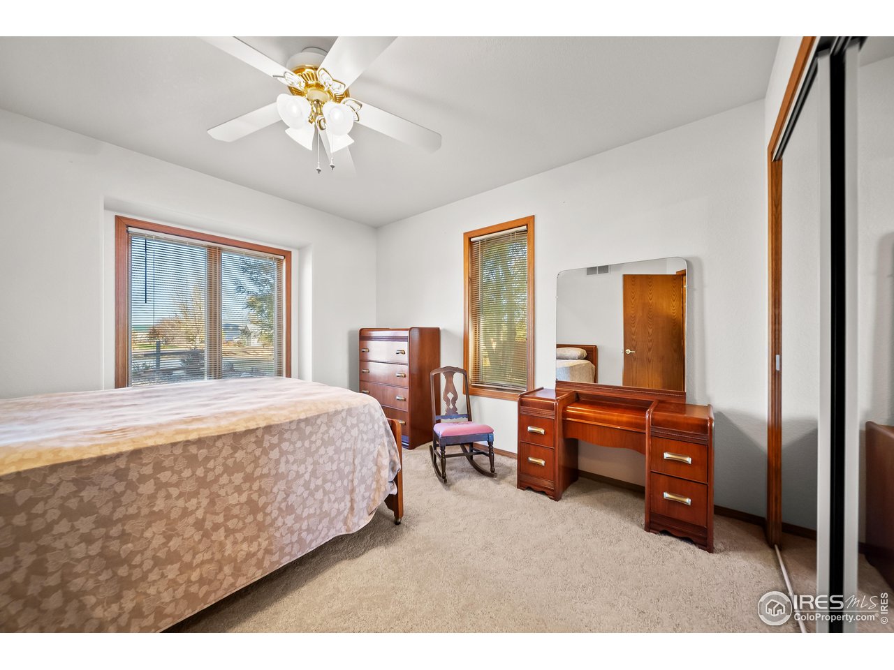 17680 County Rd Q.8 Fort Morgan, CO 80701 - Photo 16 of 40 a bedroom with a bed and a chandelier