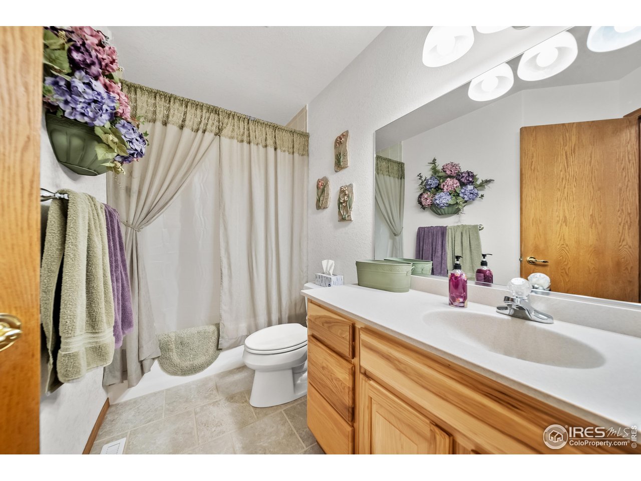 17680 County Rd Q.8 Fort Morgan, CO 80701 - Photo 17 of 40 a bathroom with a sink a toilet and a mirror