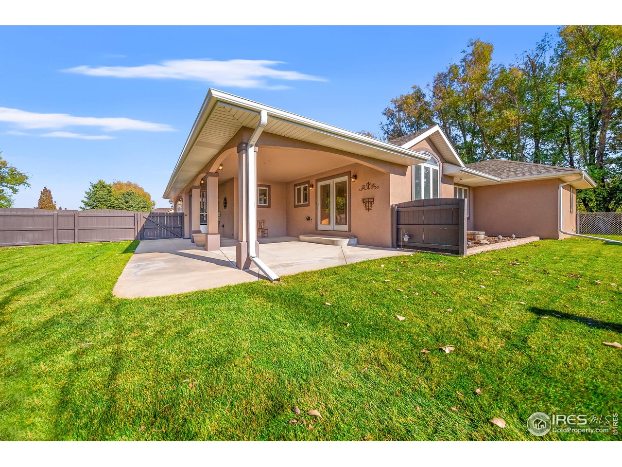 17680 County Rd Q.8 Fort Morgan, CO 80701 - Photo 26 of 40 a front view of a house with a yard and trees