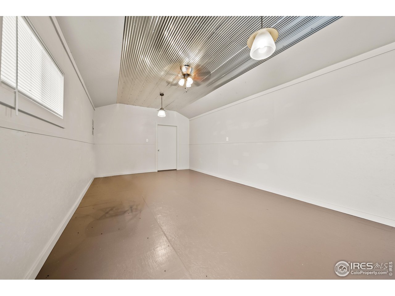 17680 County Rd Q.8 Fort Morgan, CO 80701 - Photo 31 of 40 a view of a room with wooden floor and ceiling fan