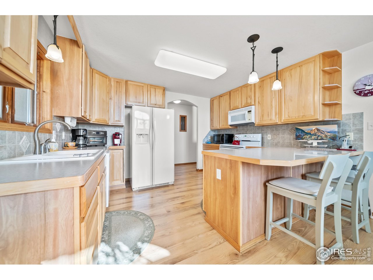 17680 County Rd Q.8 Fort Morgan, CO 80701 - Photo 9 of 40 a kitchen with kitchen island granite countertop a sink appliances cabinets and furniture