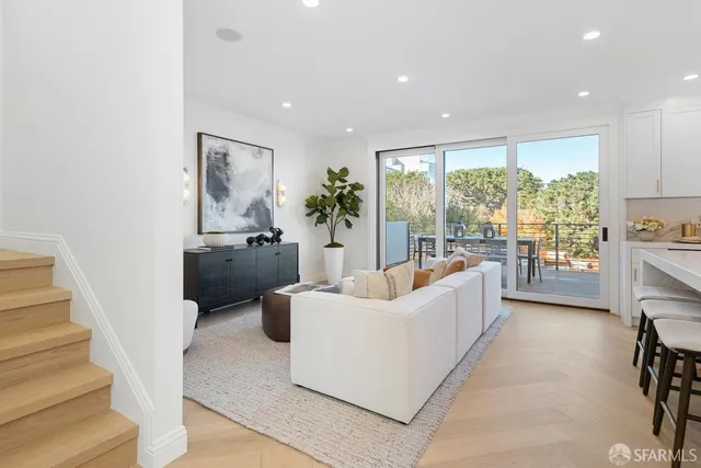 a kitchen with a sink a stove and white cabinets