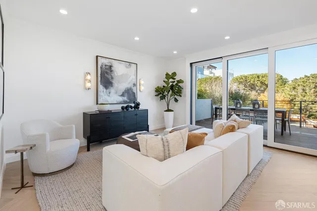 a kitchen with stainless steel appliances a dining table chairs stove and refrigerator
