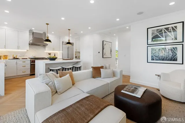 a living room with furniture and a painting on the wall