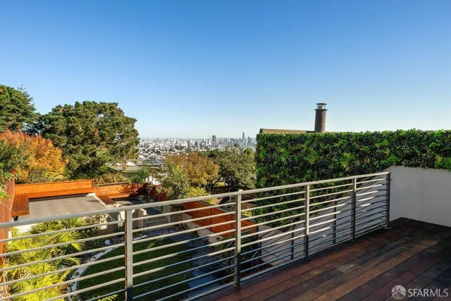 a living room with furniture and a painting on the wall