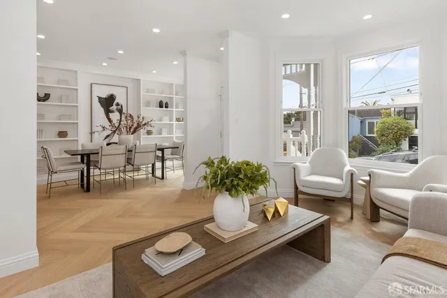 a living room with furniture kitchen and a table