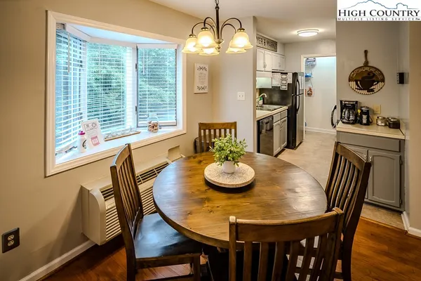 a view of a dining room with furniture window and wooden floor