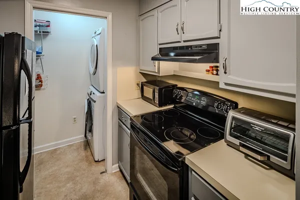 a kitchen with a stove and a refrigerator
