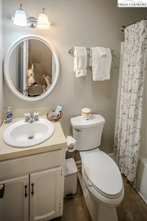 a white toilet sitting next to a bathroom sink