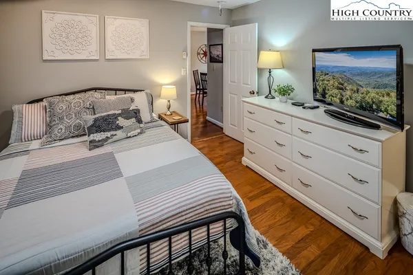 a bedroom with a bed and a flat screen tv