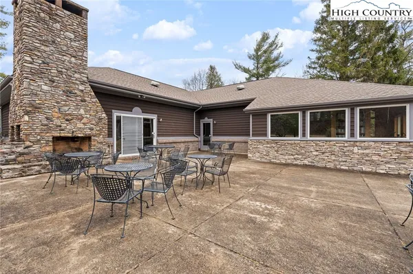 a backyard of a house with table and chairs