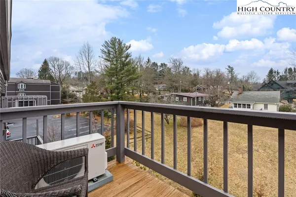 a view of a two chairs in the balcony