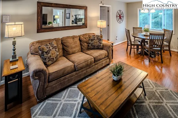 a living room with furniture and wooden floor