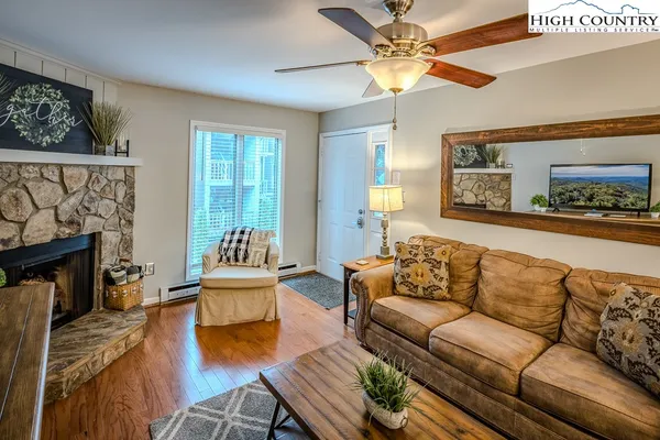 a living room with furniture and a fireplace