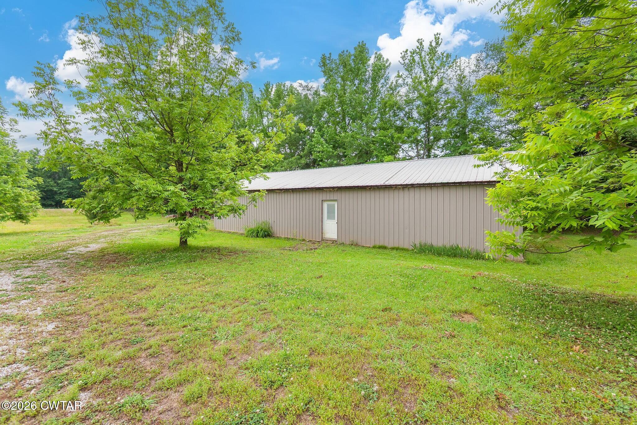 4080 Beech Bluff Road Beech Bluff, TN 38313 - Photo 6 of 41 a view of a backyard with large trees