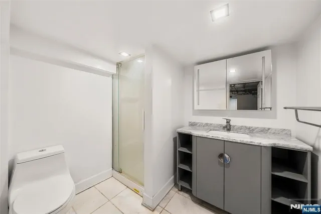 a bathroom with a sink a toilet and mirror