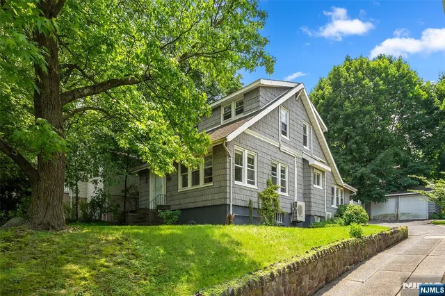 a backyard of a house with plants and tree