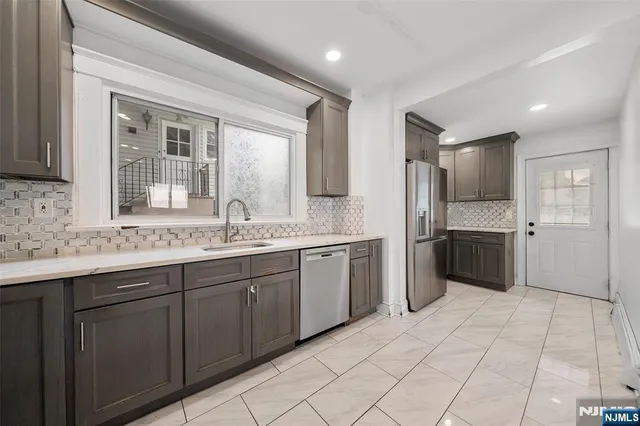 a large kitchen with a sink and cabinets