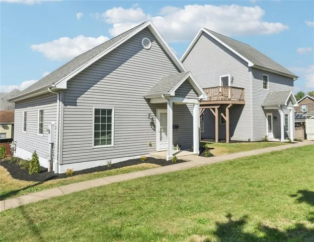 a front view of a house with a yard