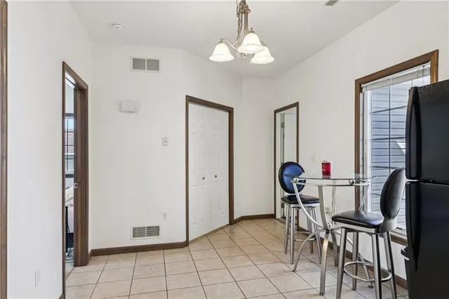 a kitchen with a refrigerator a sink dishwasher a stove with white cabinets and wooden floor