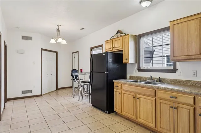 a kitchen with stainless steel appliances granite countertop a refrigerator sink and stove